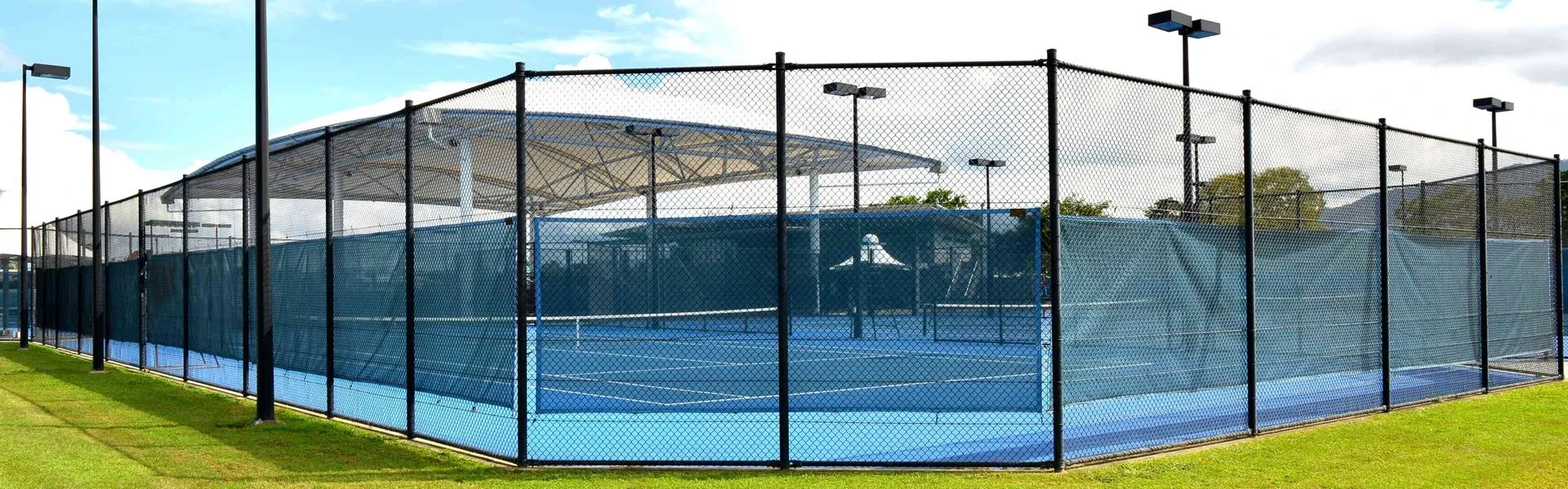 Tennis courts enclosed by chain wire fencing in North Queensland