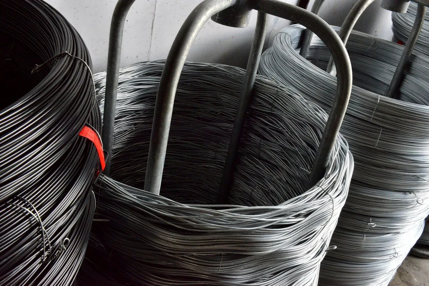 Rolls of dark chain wire mesh stacked in the factory