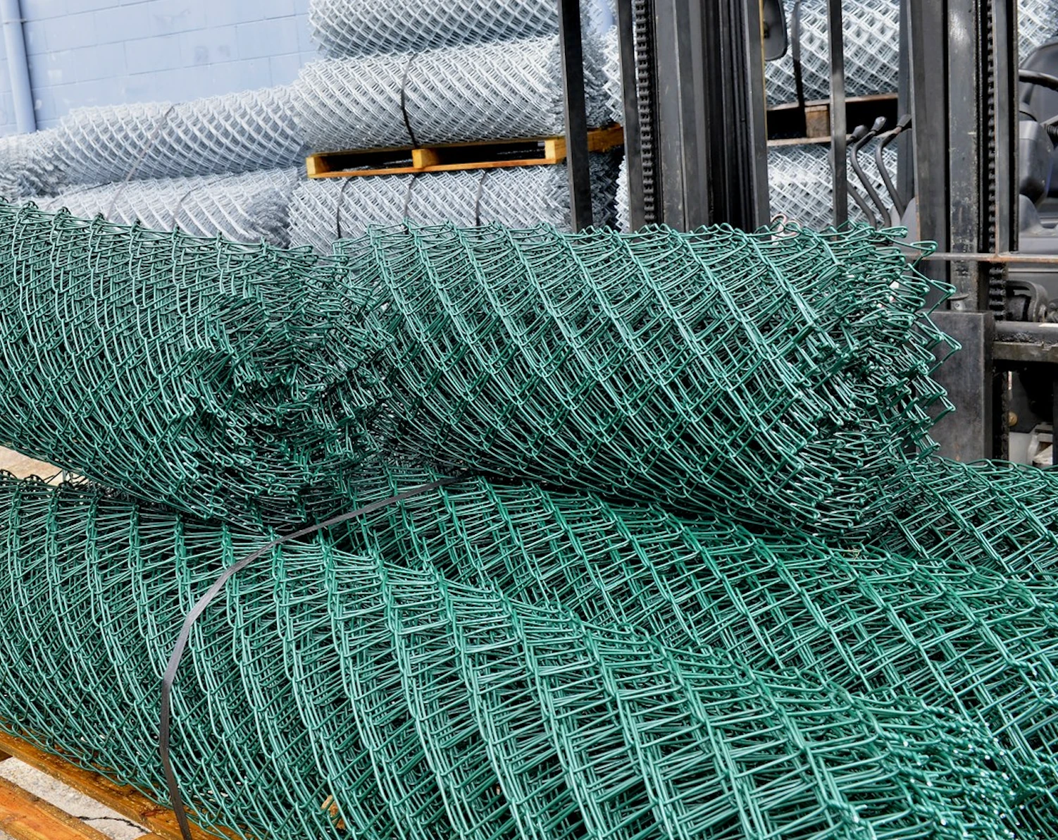 Rolls of green PVC coated chain wire mesh in the factory