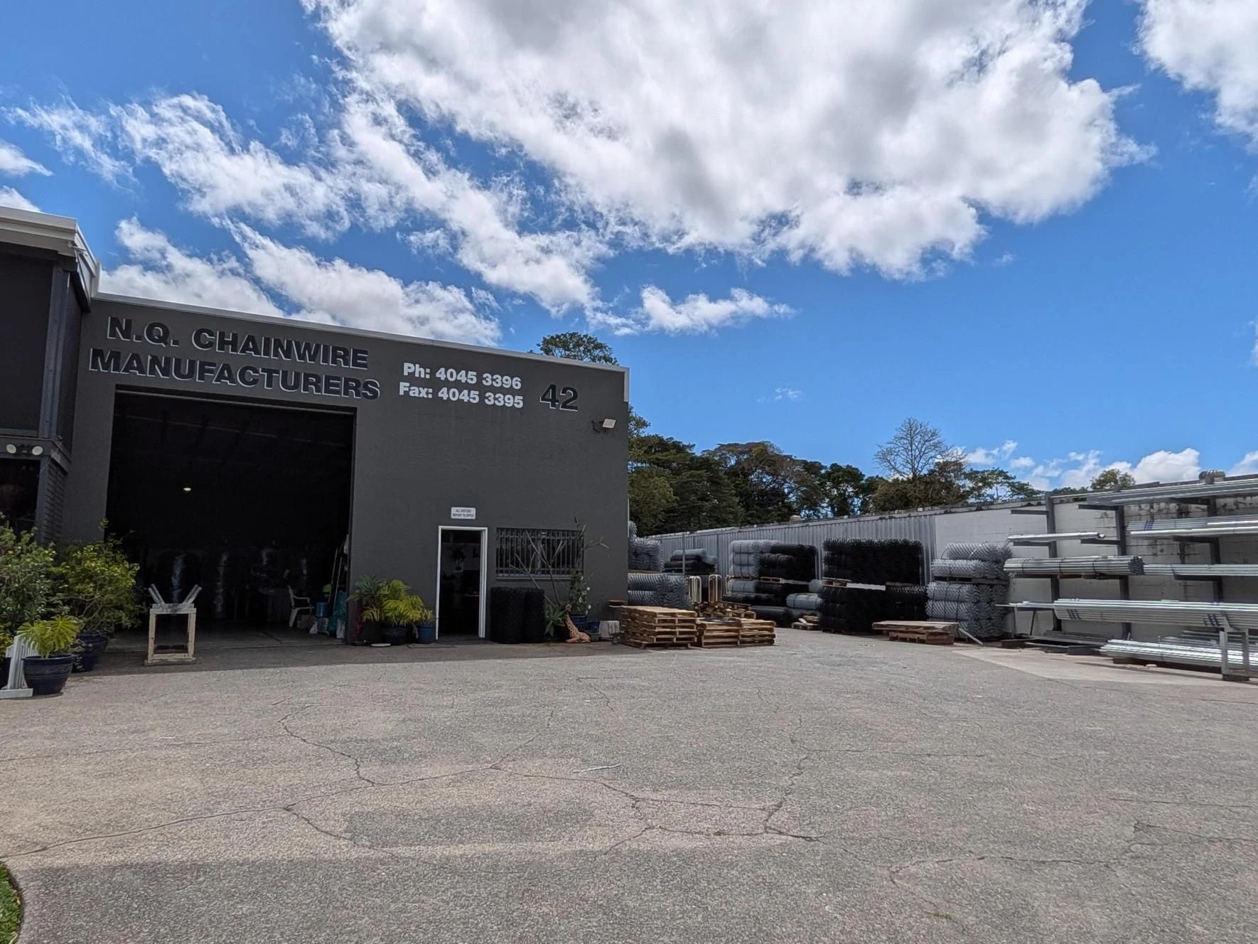 Stock and signage in the yard at the NQ Chain Wire Manufacturers factory