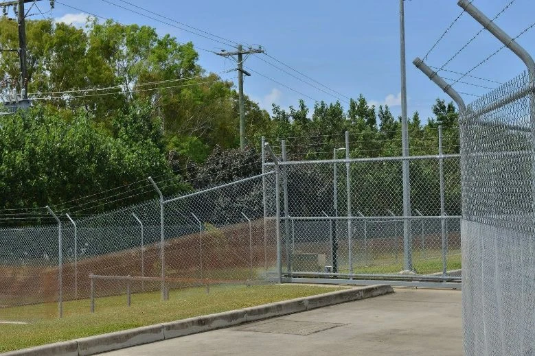 Galvanised security fence and gate with barbed wire topping
