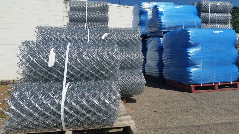 Rolls of galvanised chain wire mesh stacked in the yard