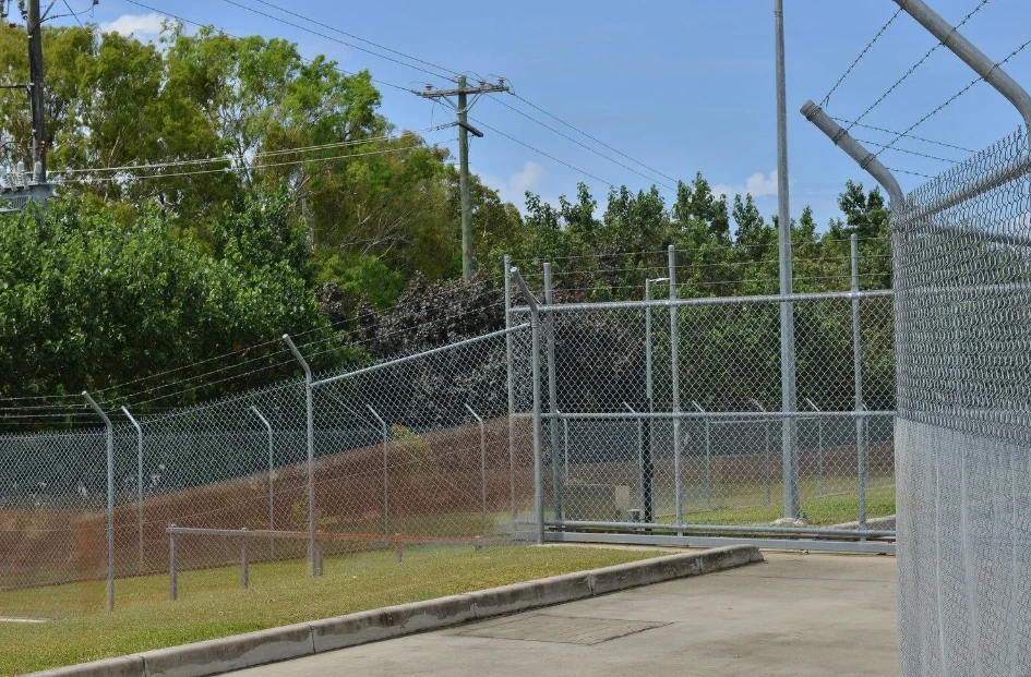 Galvanised security fence and gate across a commercial driveway